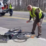 A cyclist rides along Alpine Road, where the Portola Valley care bike accident occurred, highlighting the need for improved safety measures.