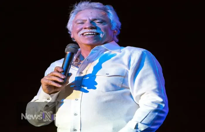 Joe Bonsall, tenor singer of The Oak Ridge Boys, performing on stage with his signature energy and enthusiasm.